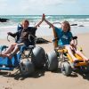 Children in Sandcruiser and Sandpiper wheelchairs